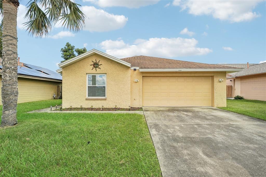 a front view of a house with a yard and garage