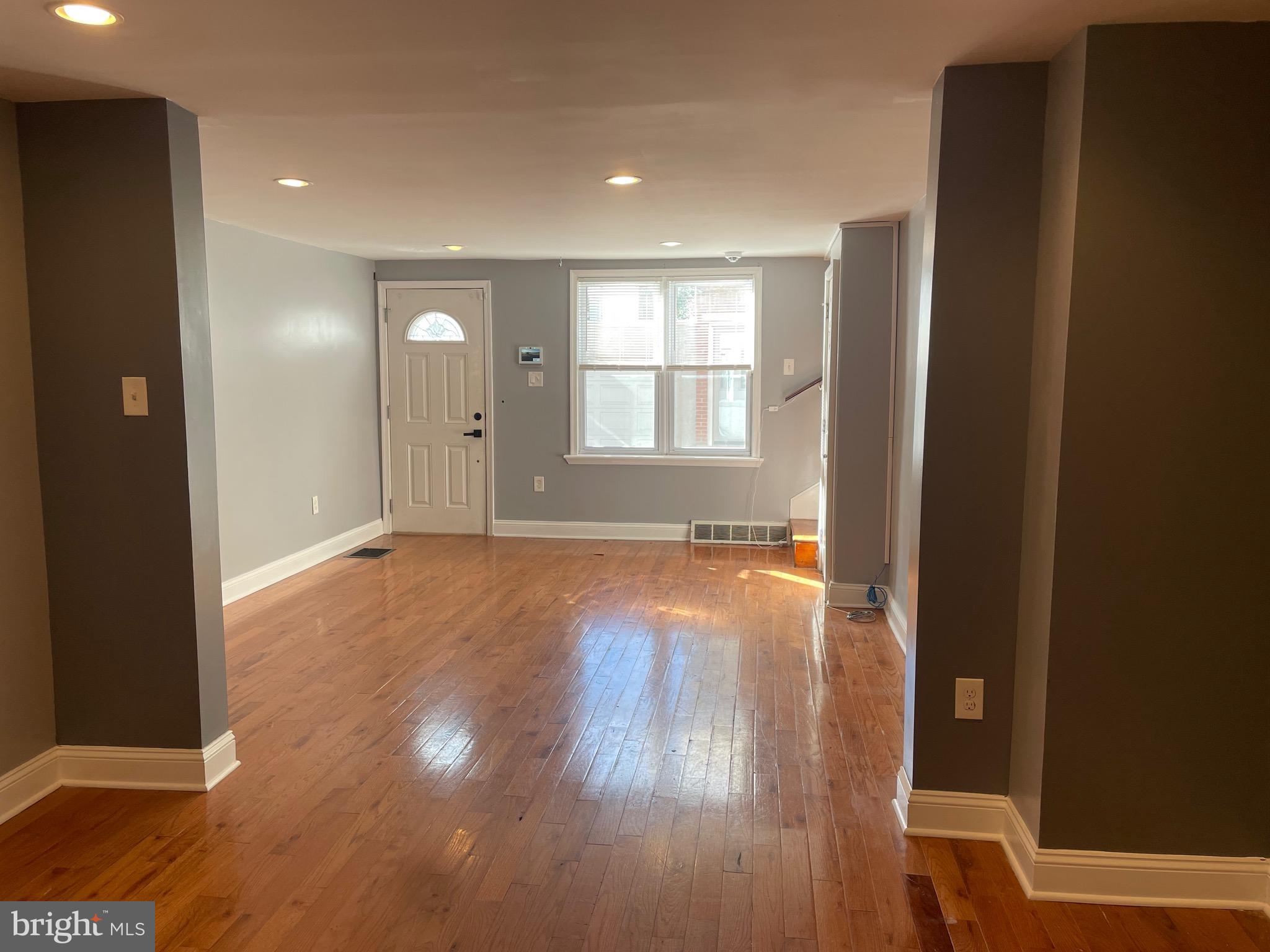 a view of wooden floor and windows in a room