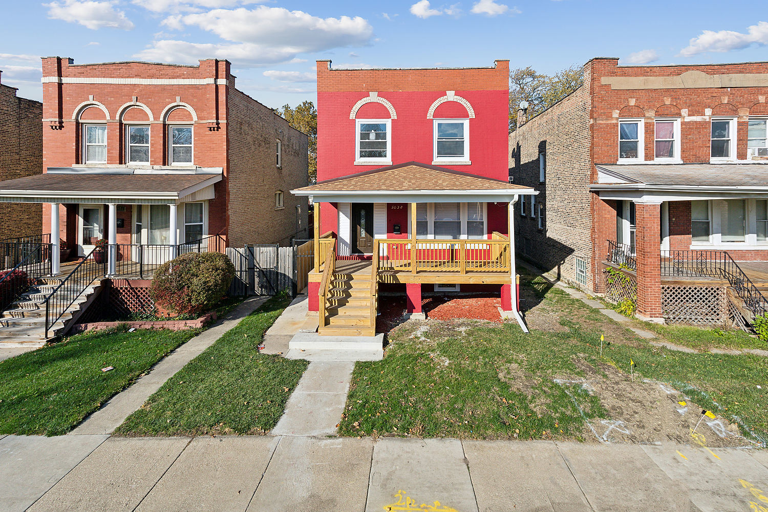 front view of a brick building with a yard