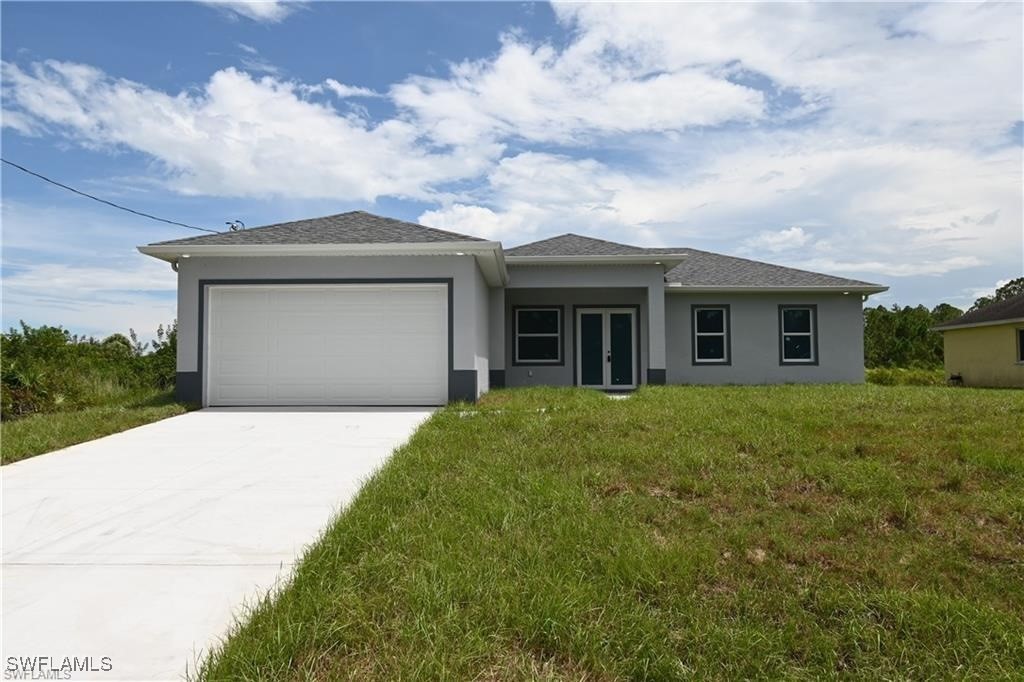 a front view of house with yard and green space