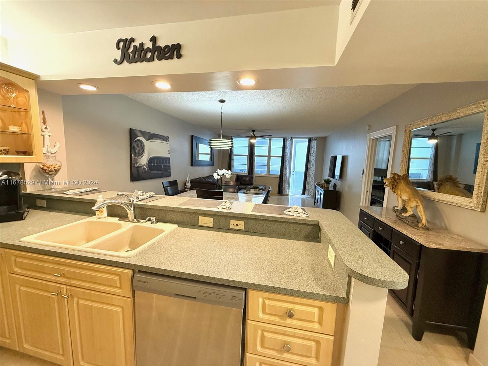 a large kitchen with a sink and cabinets