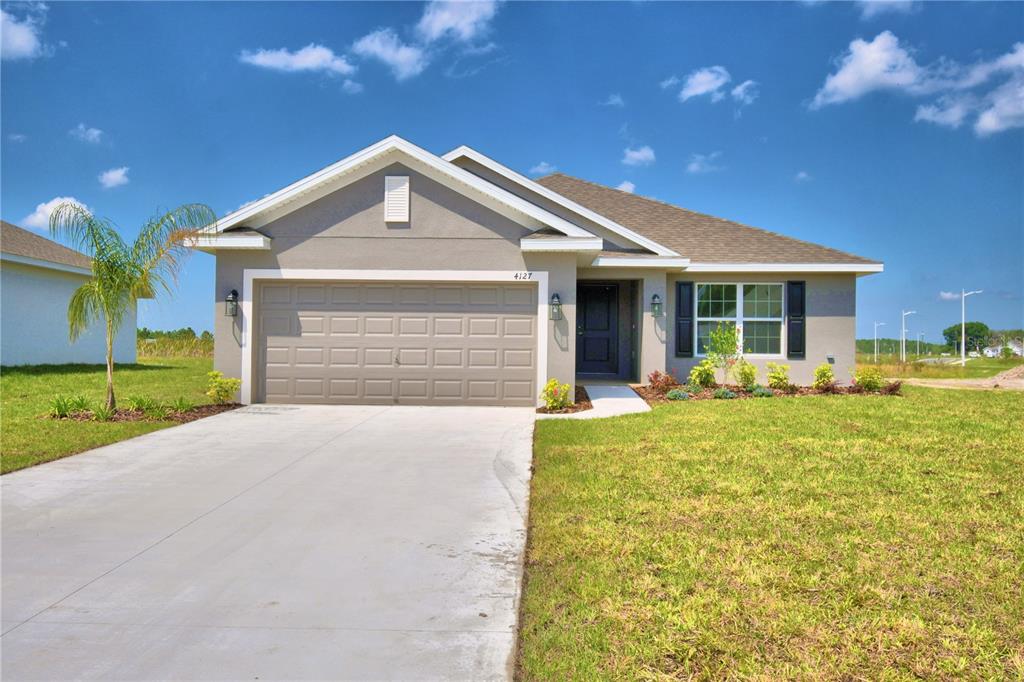 a view of a house with a yard and garage