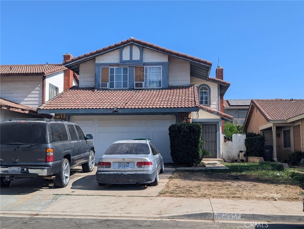 a front view of a house with a parking space