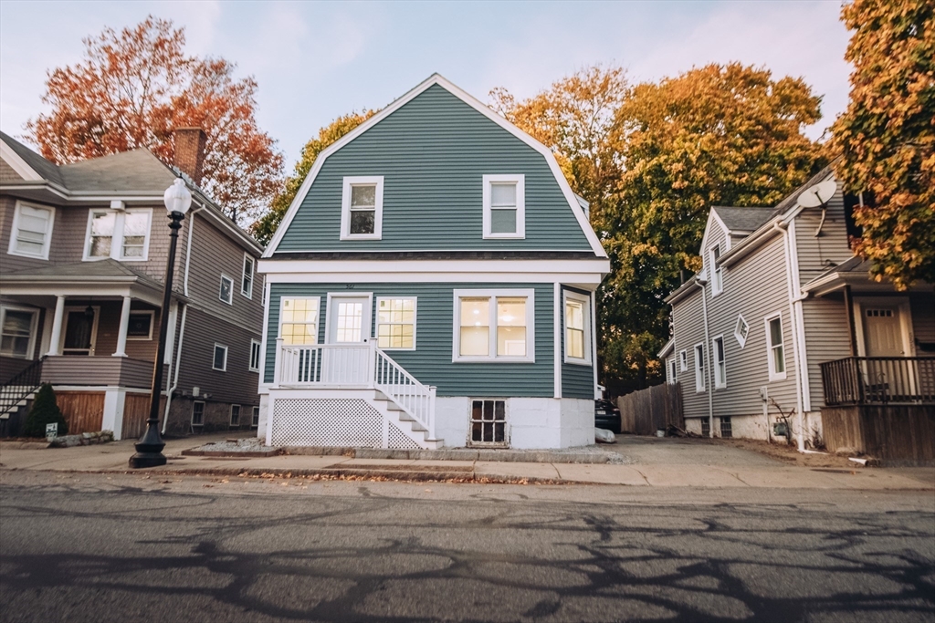 a front view of a house with a yard