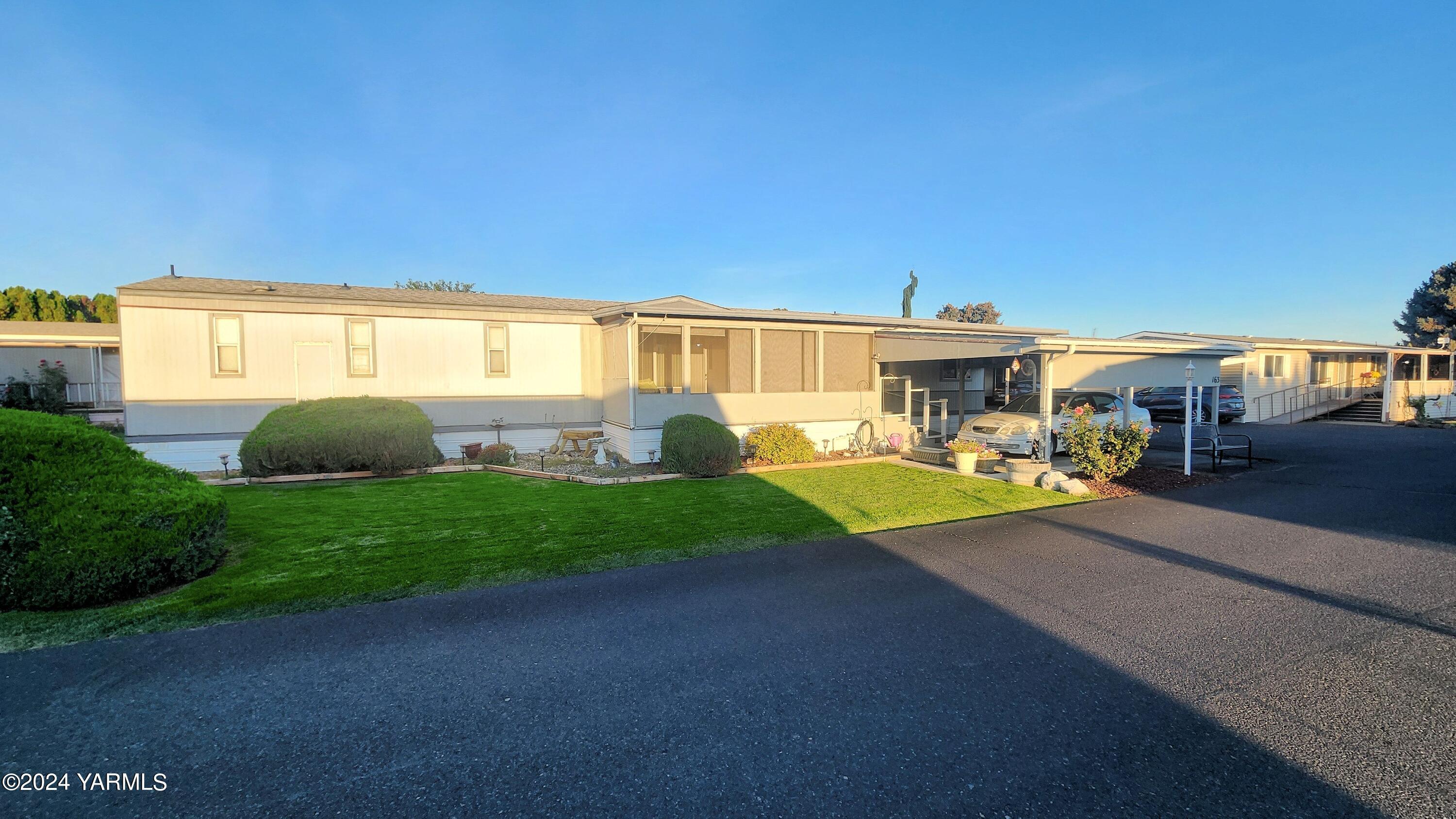 a view of a house with backyard and a garden