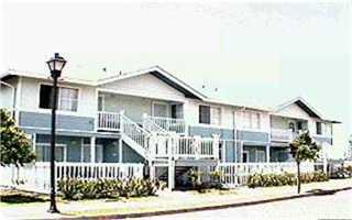 a view of a house with wooden fence