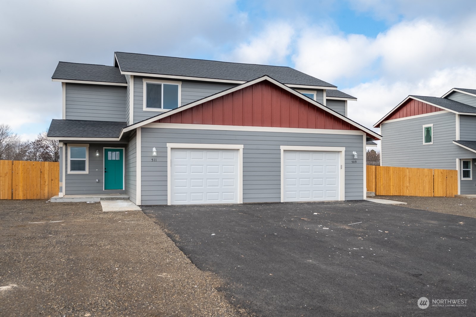 a view of house with yard and a garage