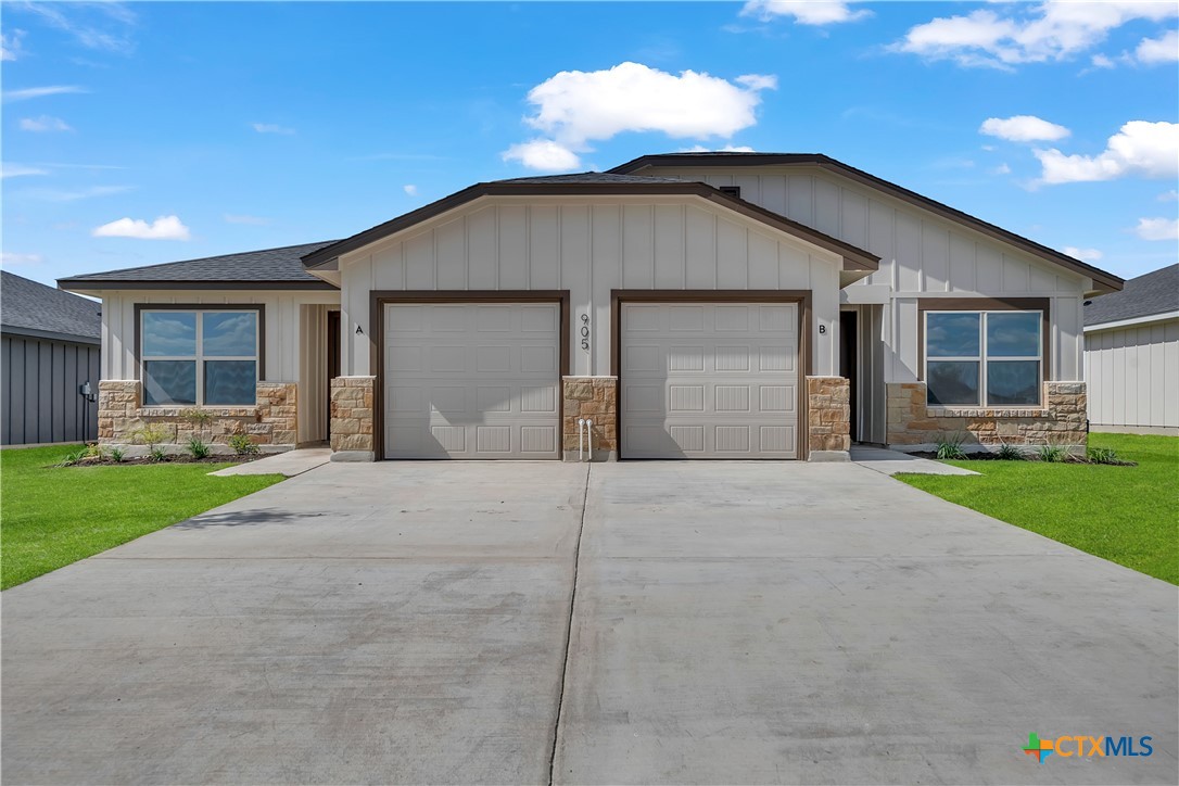 a view of a house with a yard and garage