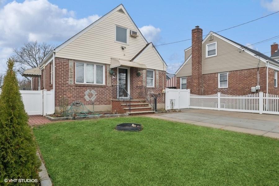 a front view of house with yard and front view of a house