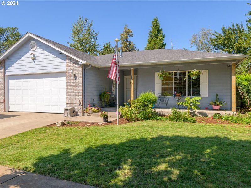 a view of a house with a yard and sitting area