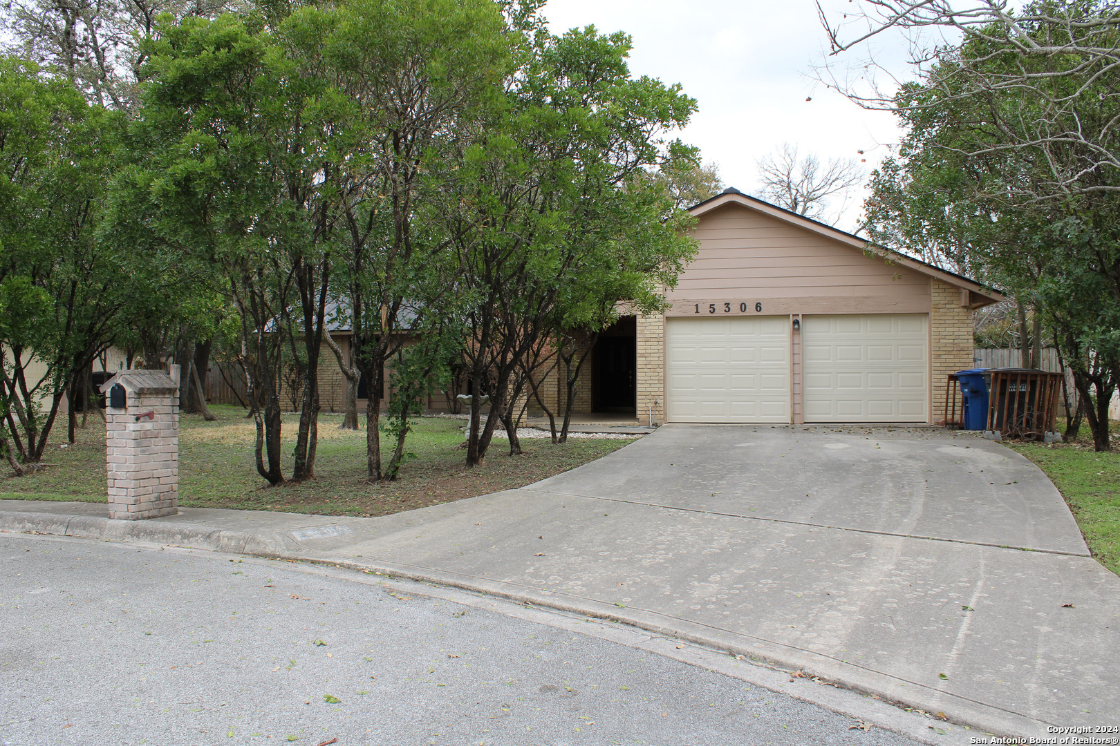 a view of a house with a outdoor space and trees