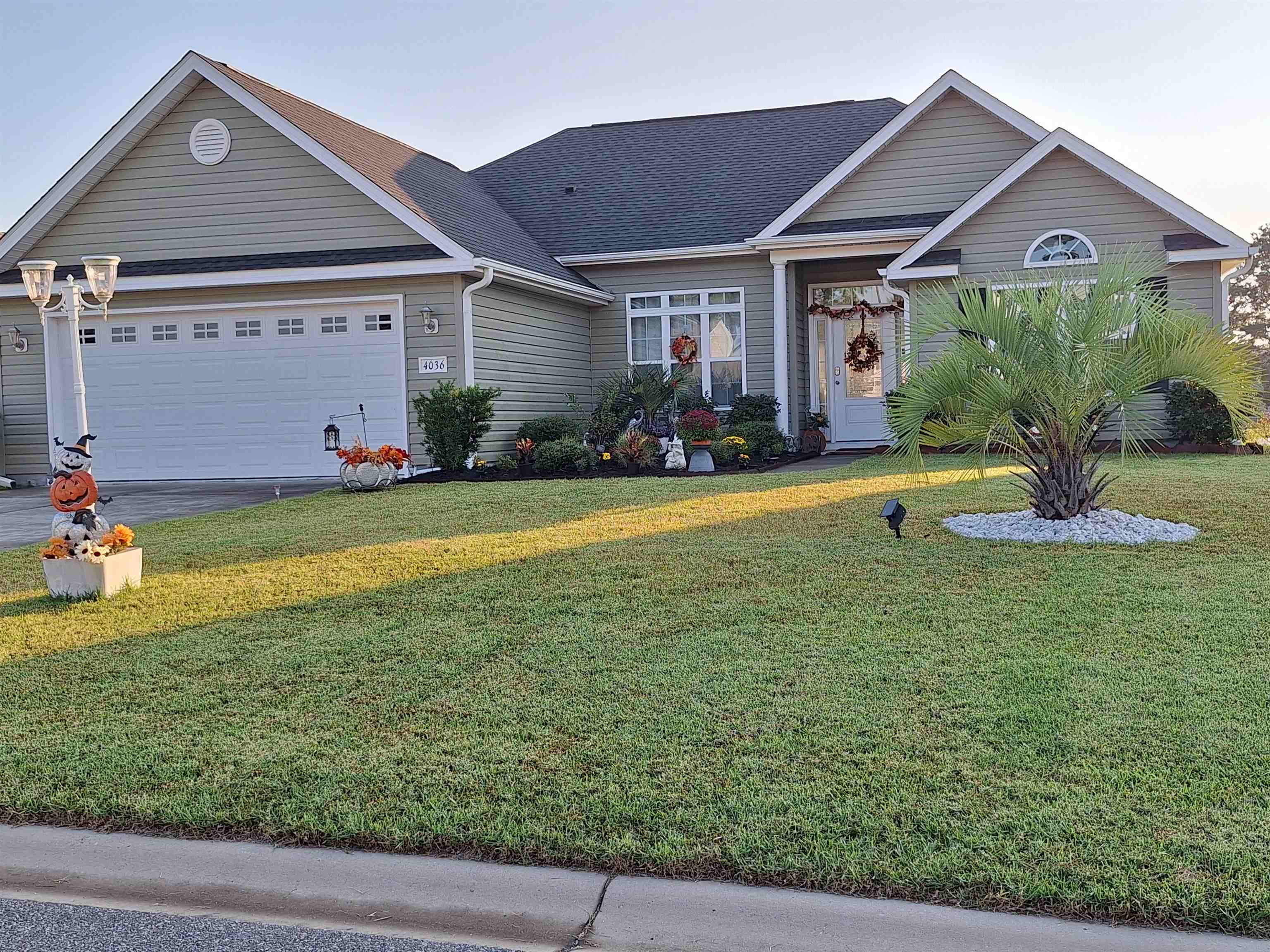 View of front of home with a garage and a front la