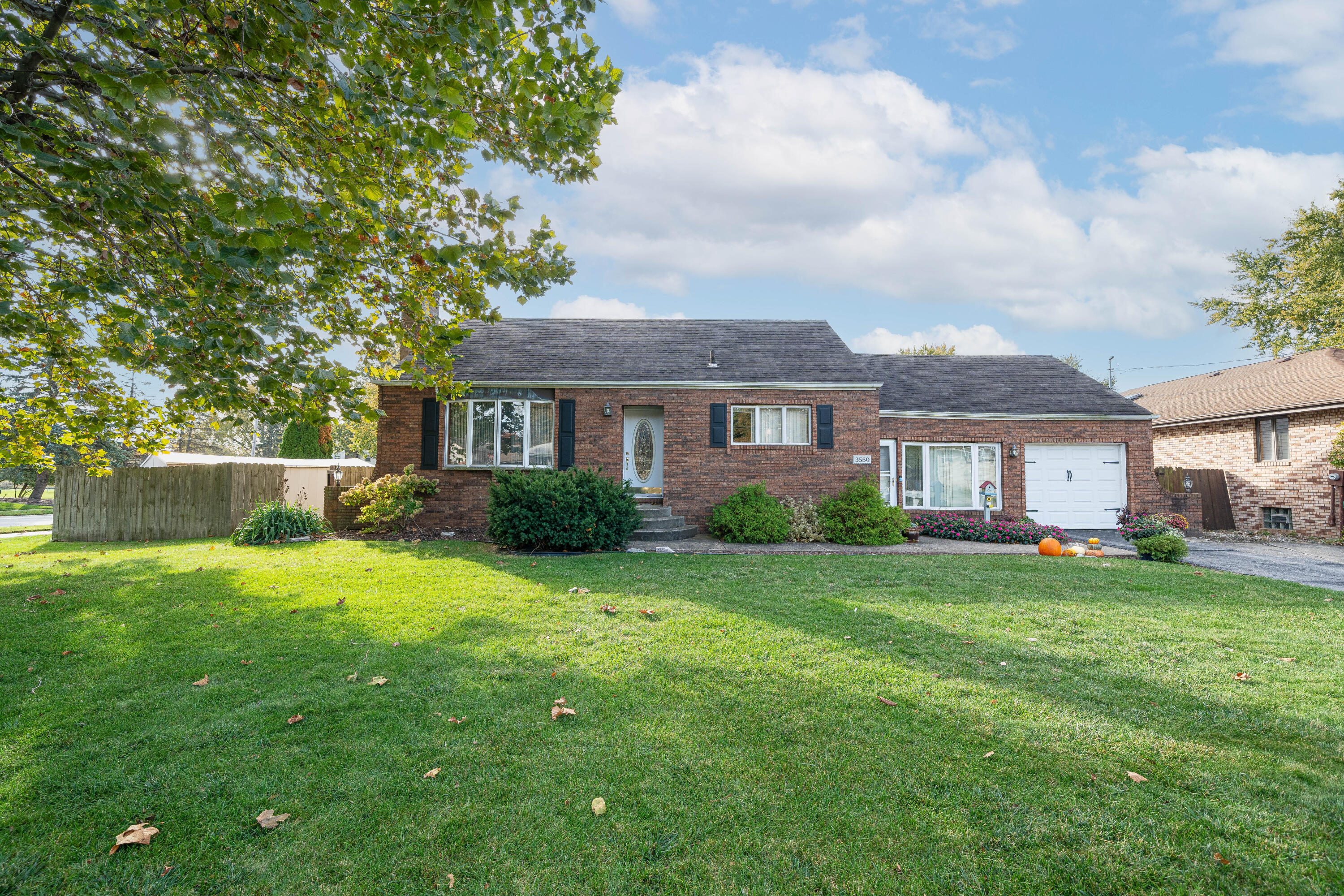 a house view with a sitting space and garden