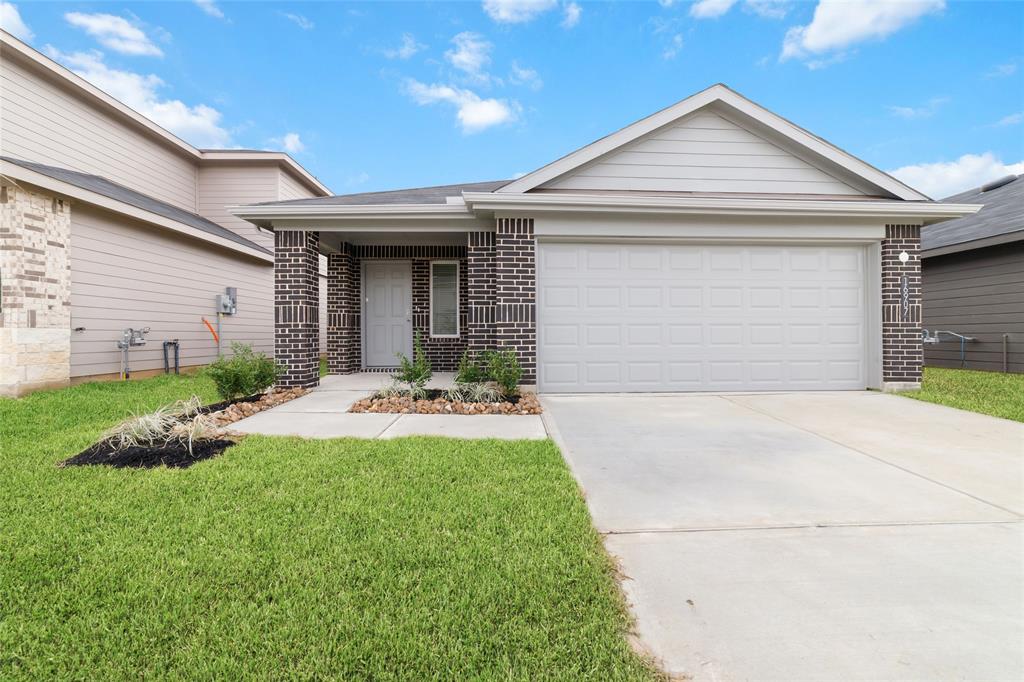 a front view of a house with a yard and garage