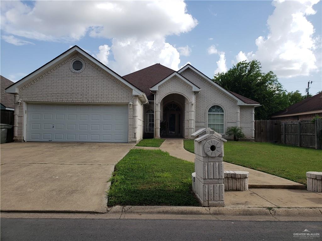 View of front of home featuring a garage and a front lawn