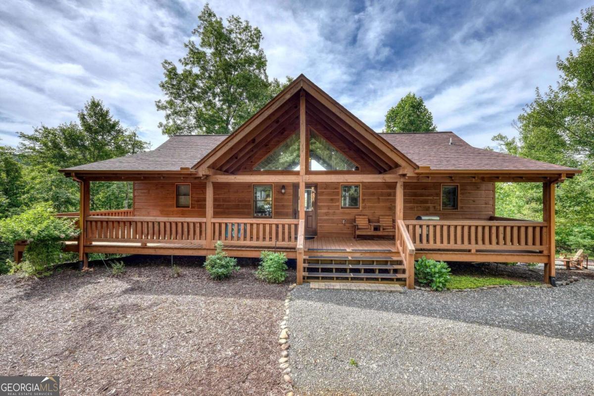 a view of a house with a yard and deck