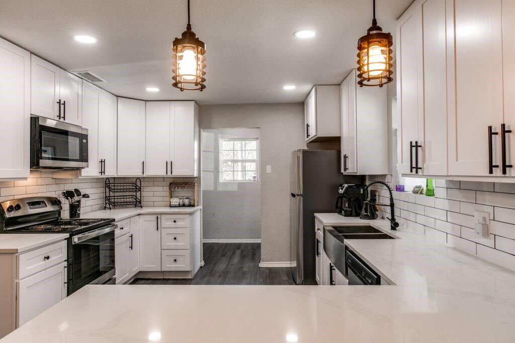 a kitchen that has a lot of cabinets a sink and a stove