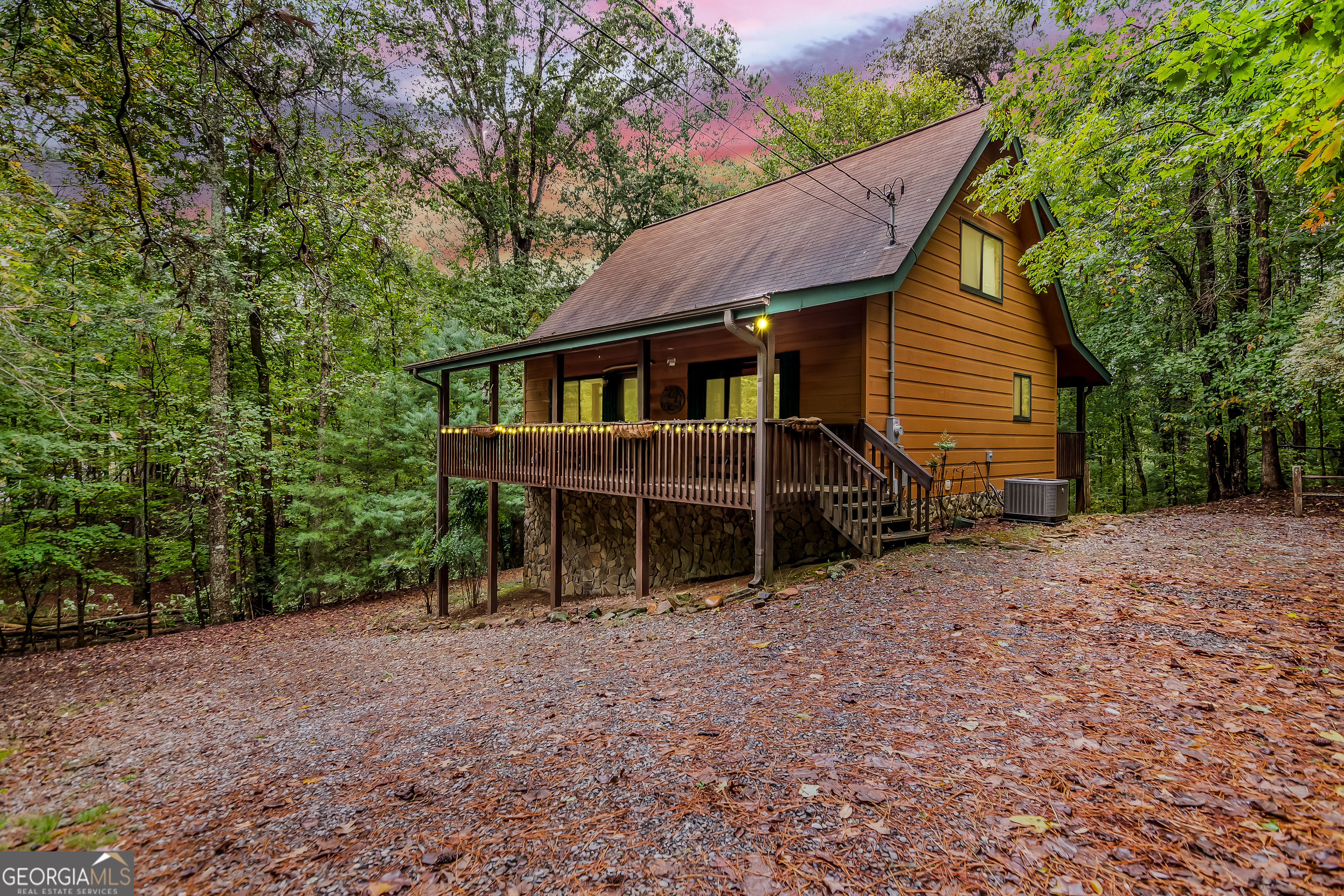 a view of house with backyard and trees