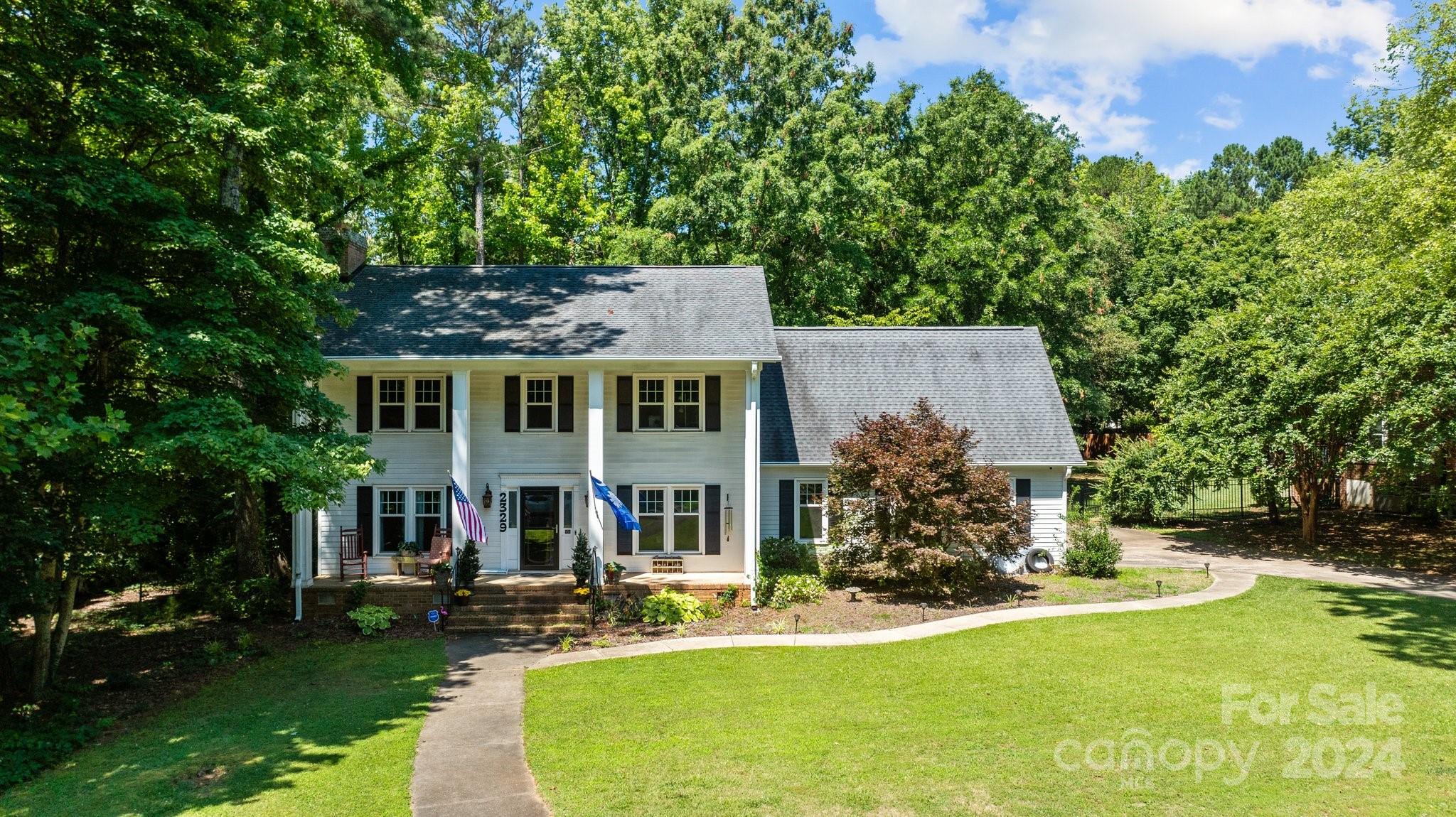 an aerial view of a house with swimming pool garden and patio