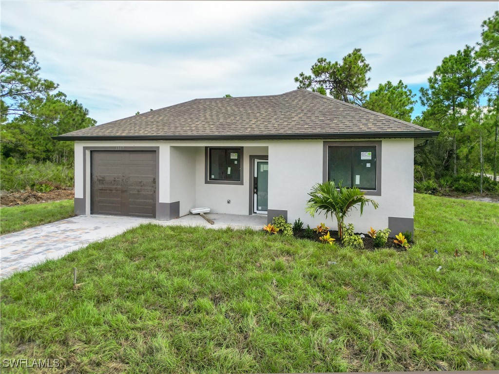 a front view of house with yard and green space