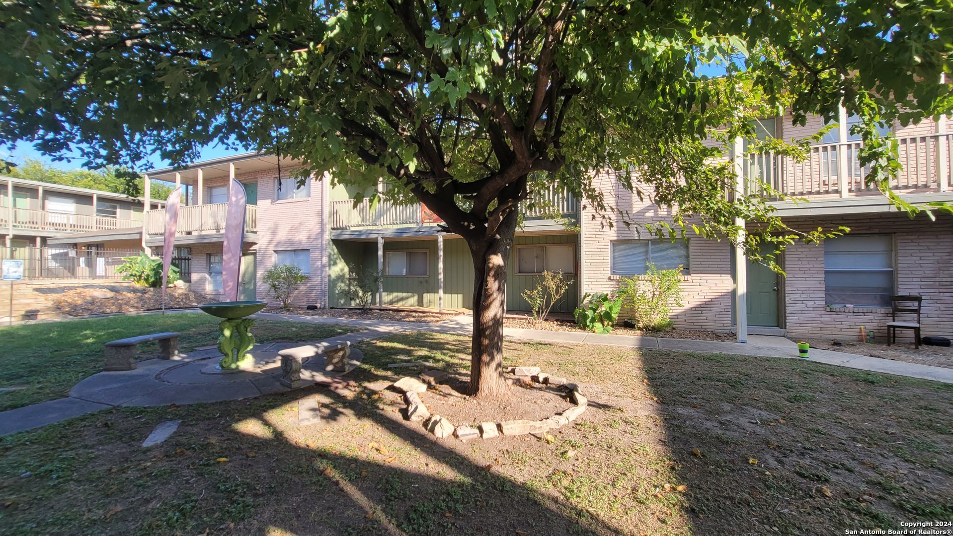 a view of a house with backyard and sitting area