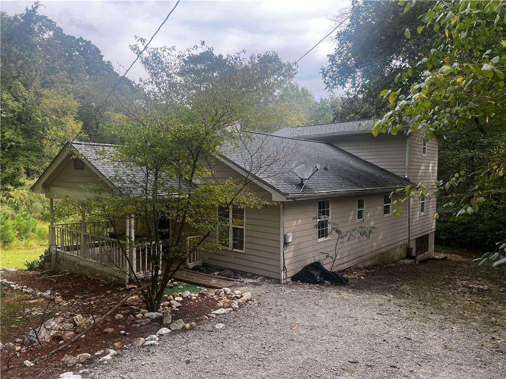 a view of a house with a yard and tree s