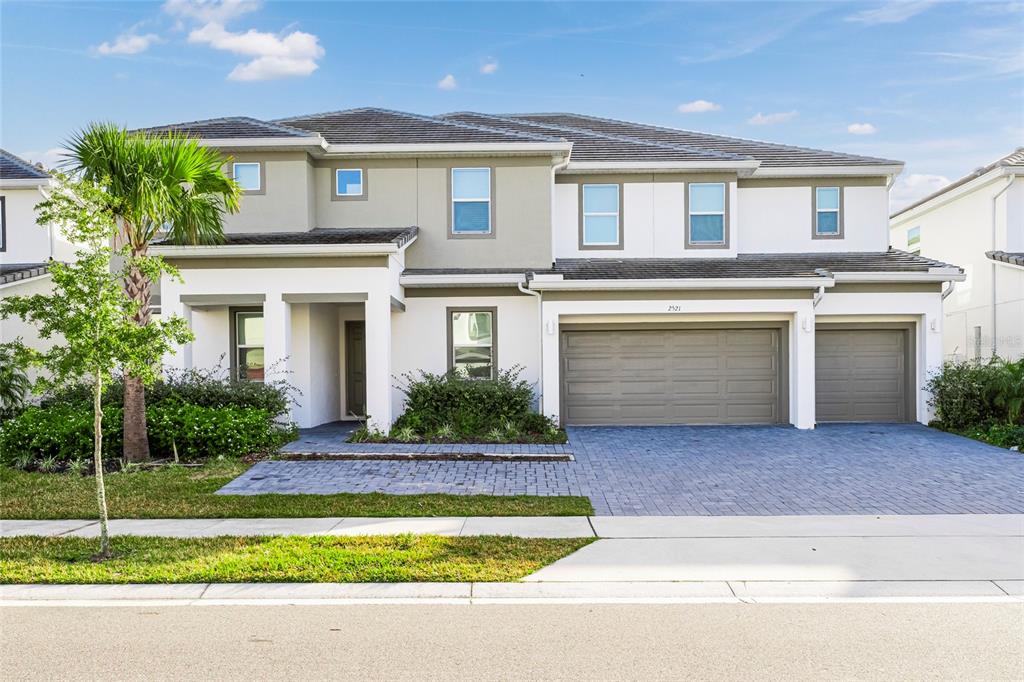 a front view of a house with a yard and garage