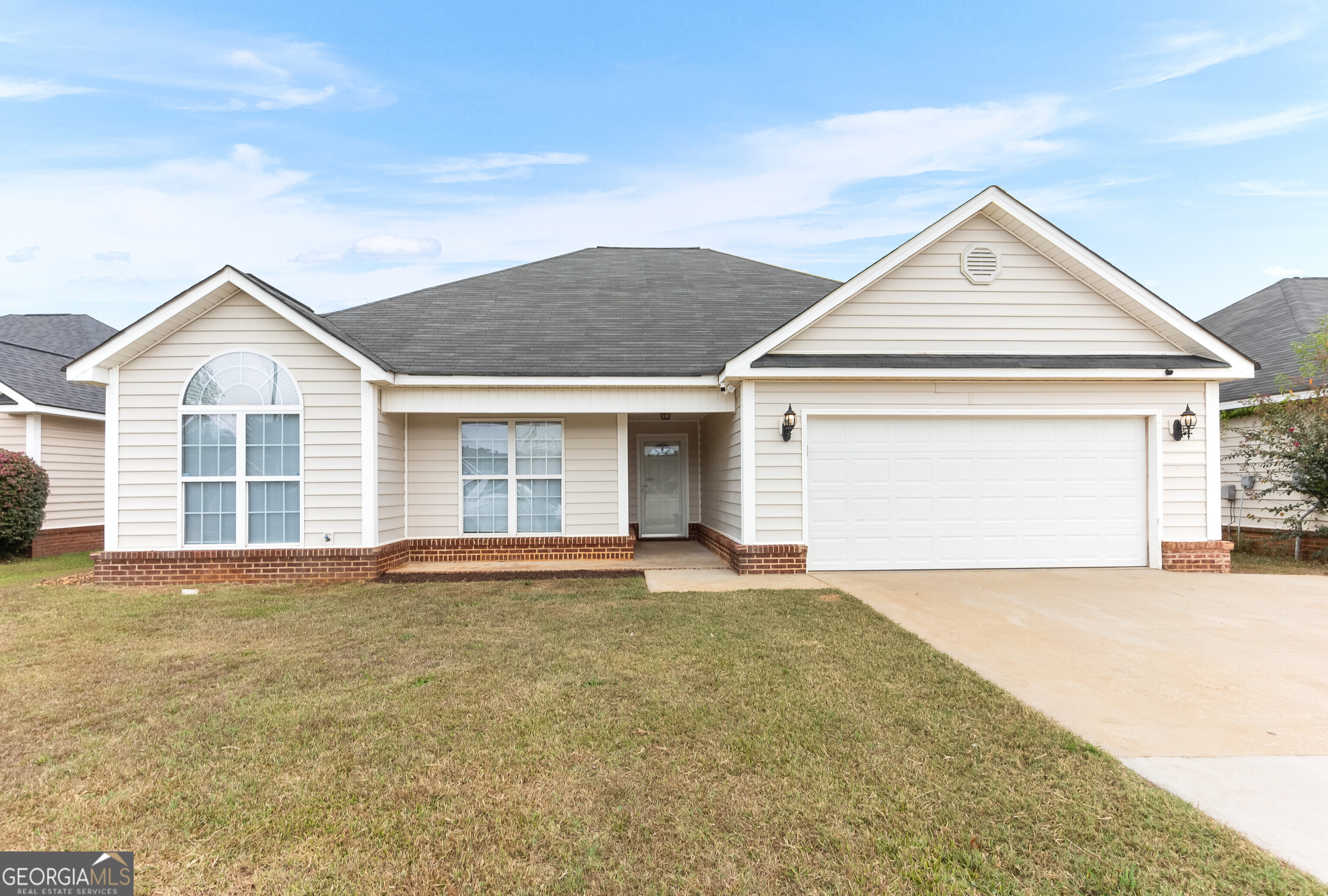 a view of a house with a yard and garage