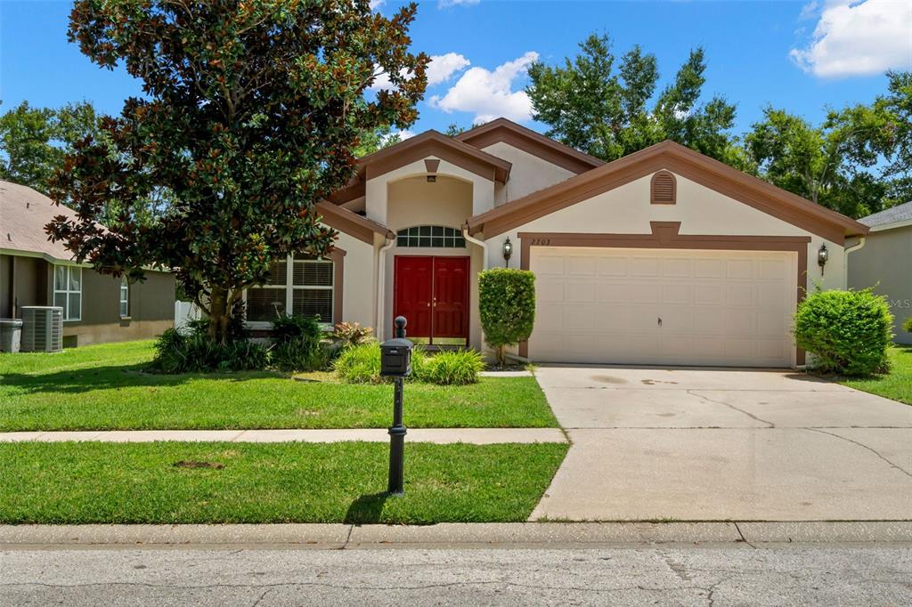 a front view of a house with a yard and garage