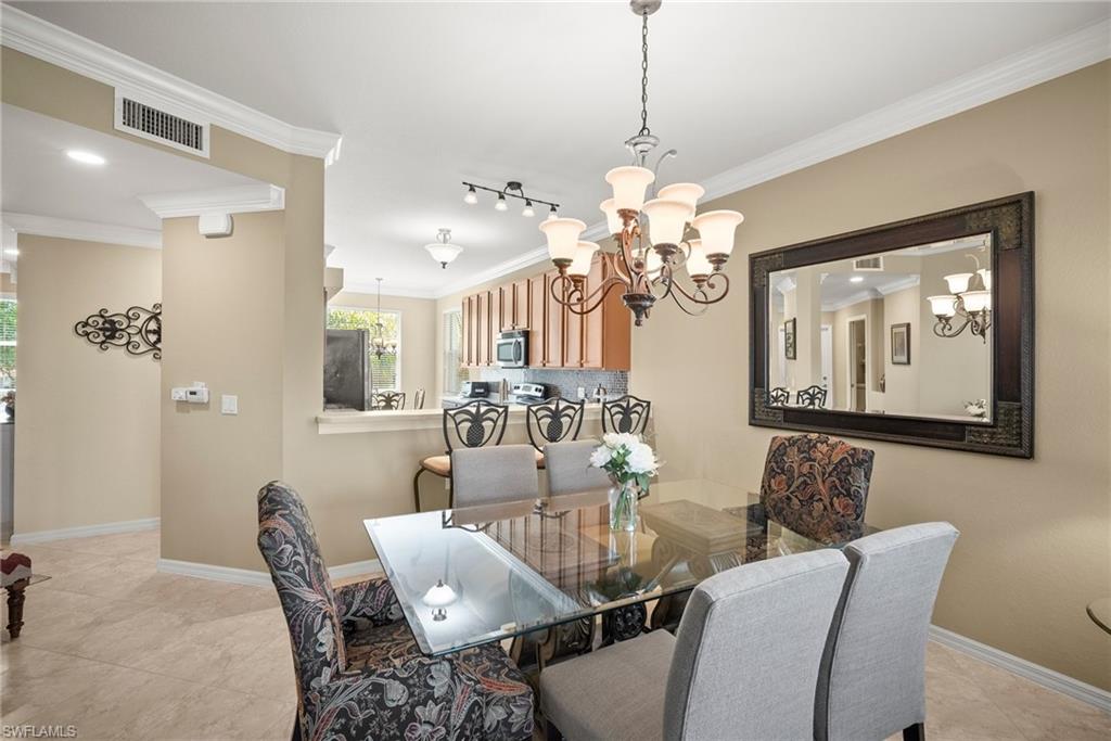 a view of a dining room with furniture and chandelier