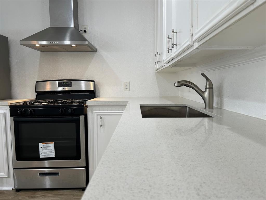 a kitchen with granite countertop a stove and a microwave