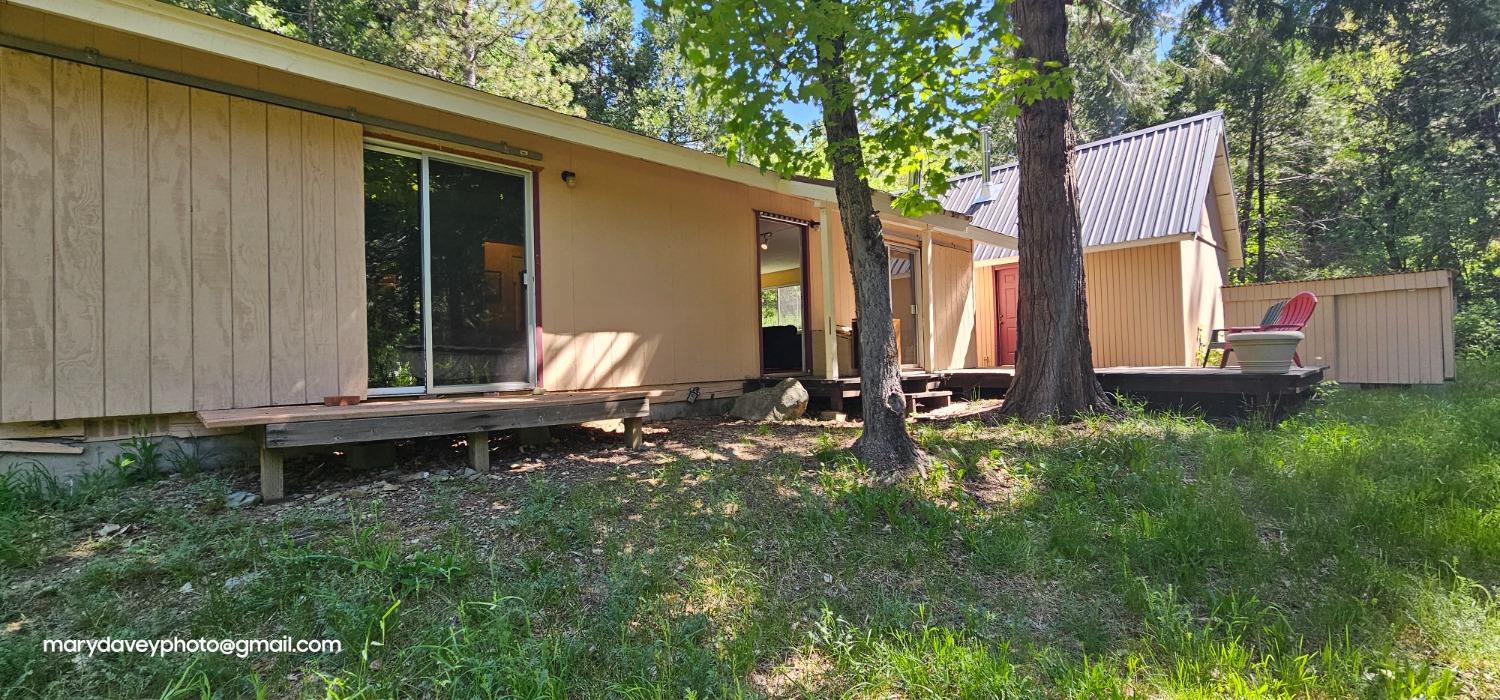 a backyard of a house with barbeque oven and outdoor seating