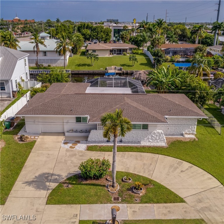 an aerial view of a house with a yard