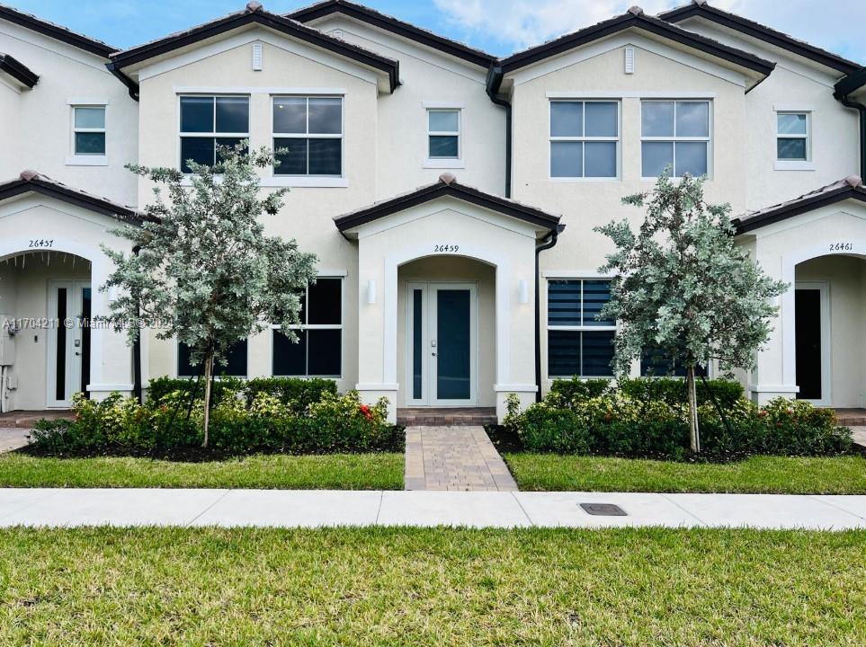 a front view of a house with a yard