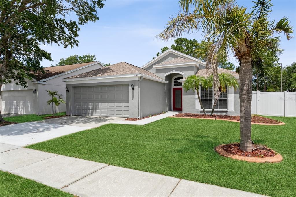 a front view of a house with a yard and garage