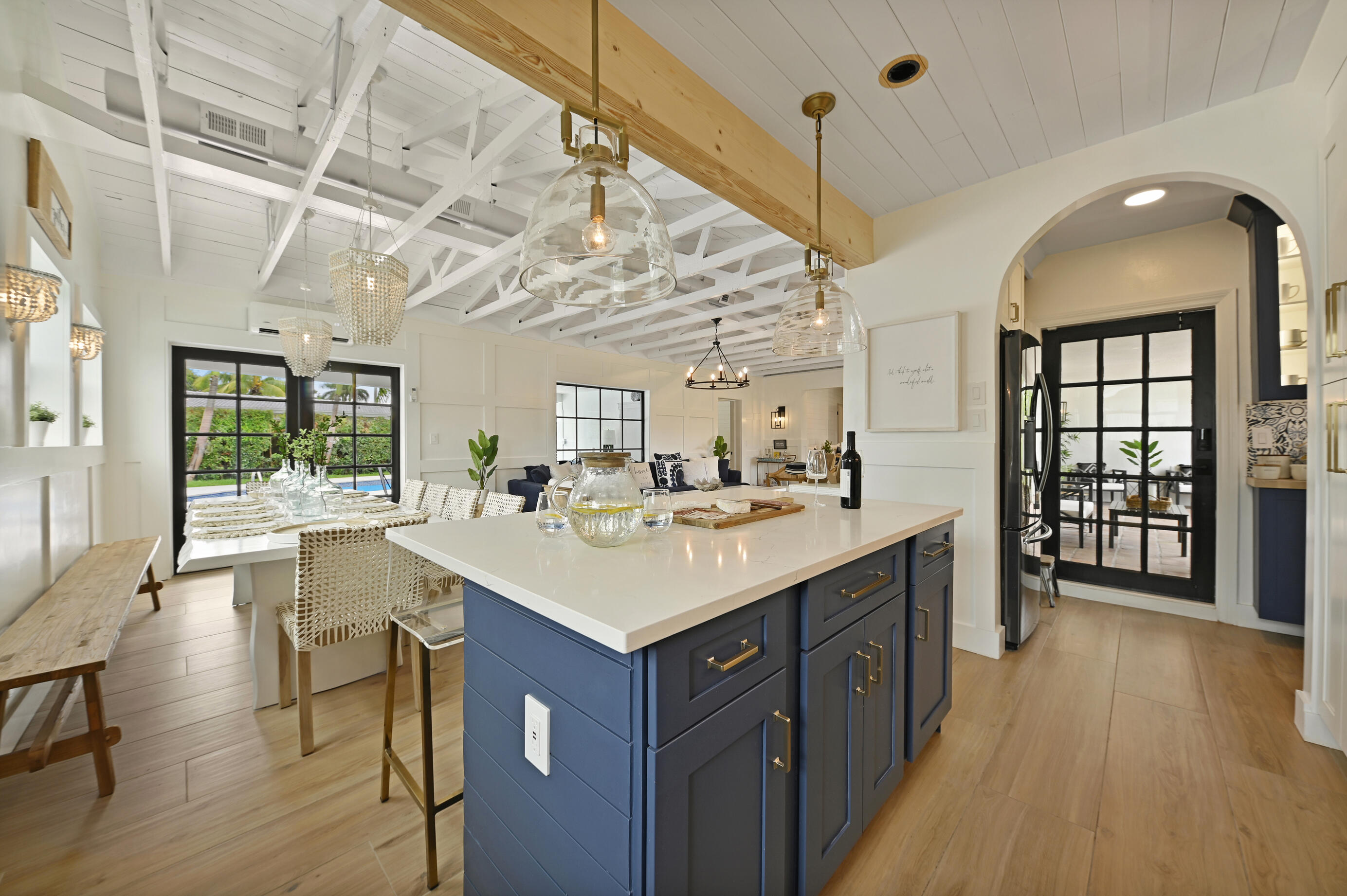 a kitchen with a sink and wooden floor