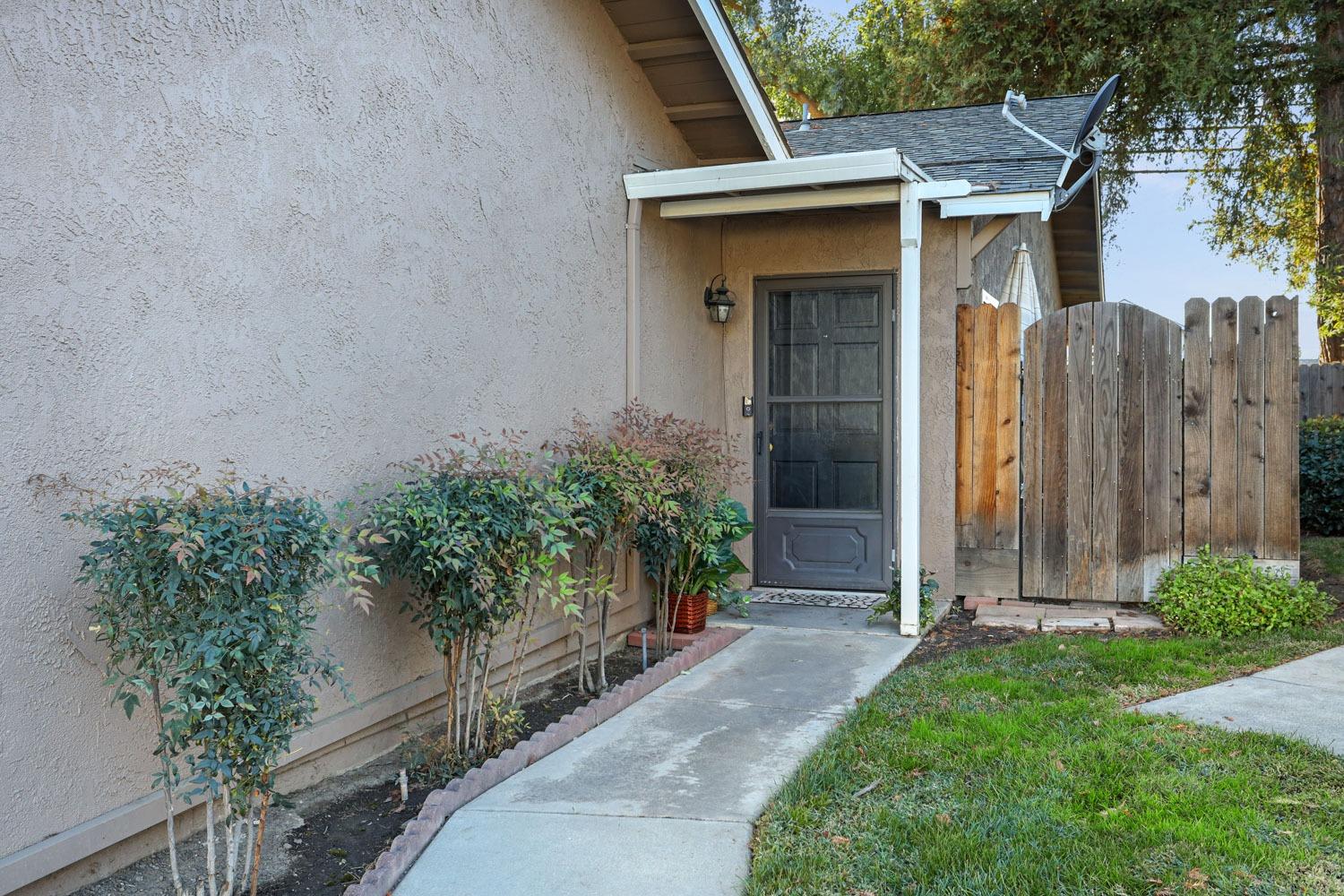 a view of small house with potted plants