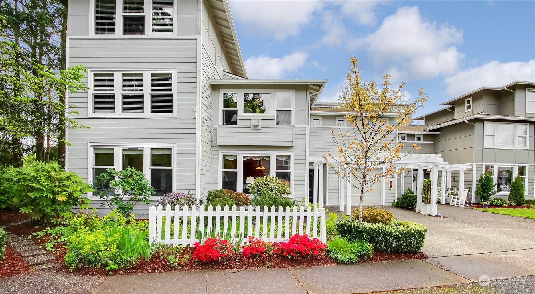 a front view of a house with a garden