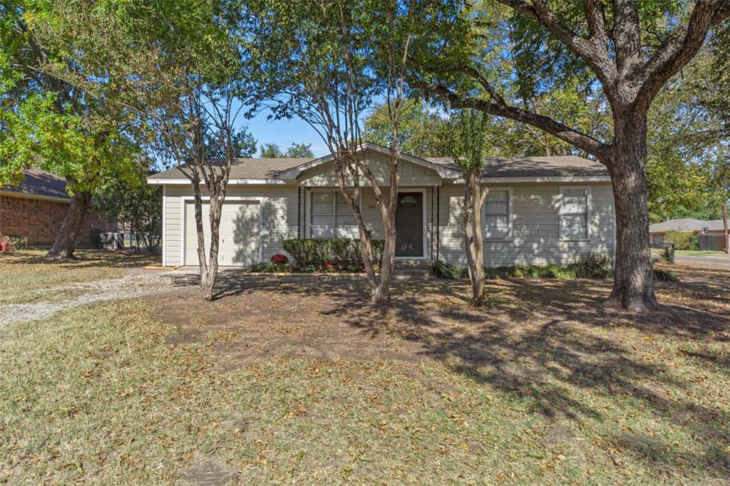 front view of a house with a tree