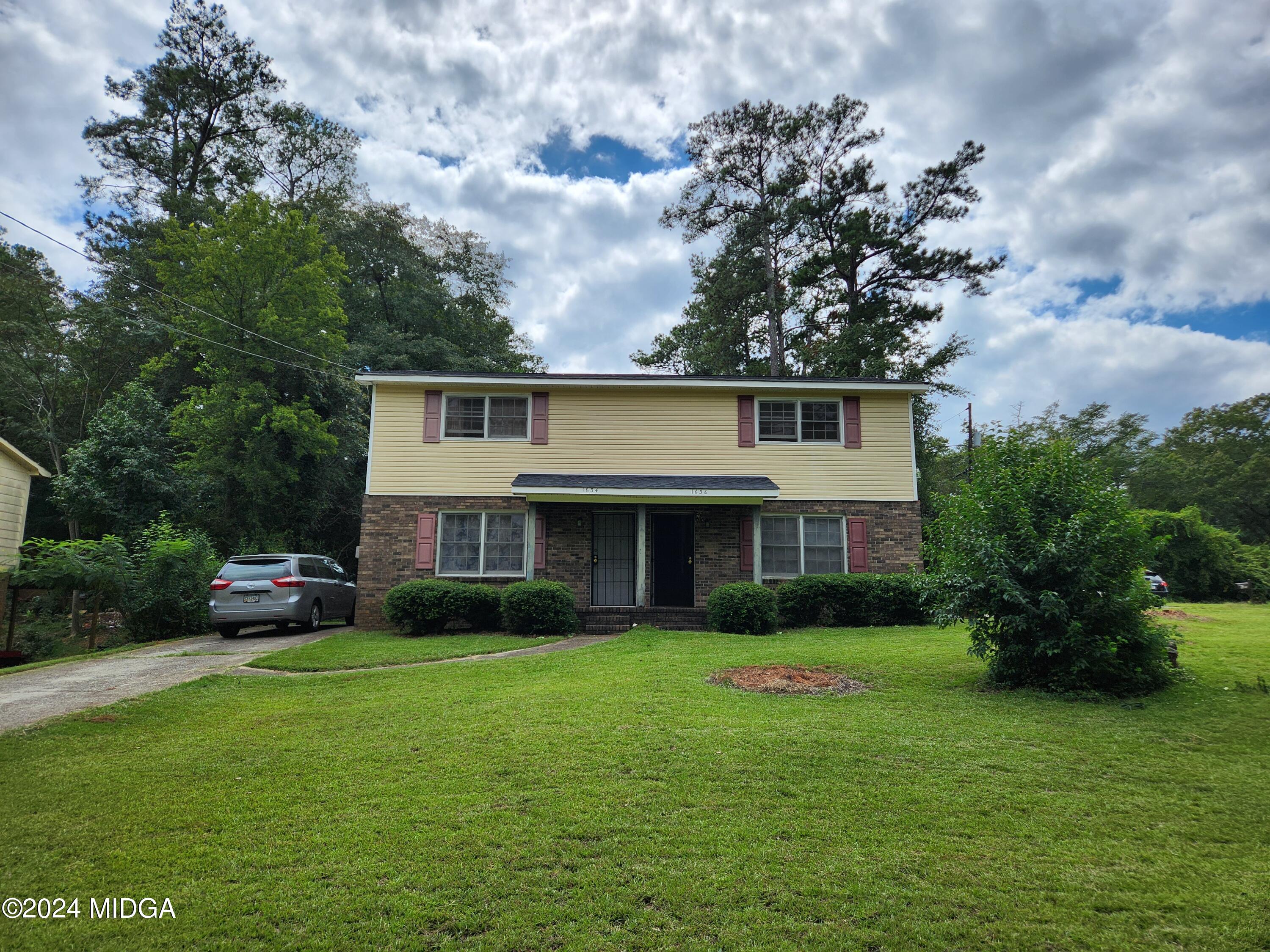 a front view of house with yard and green space