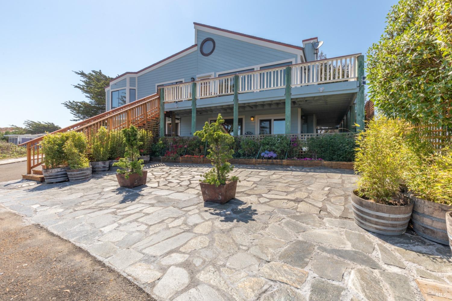 a front view of a house with a garden