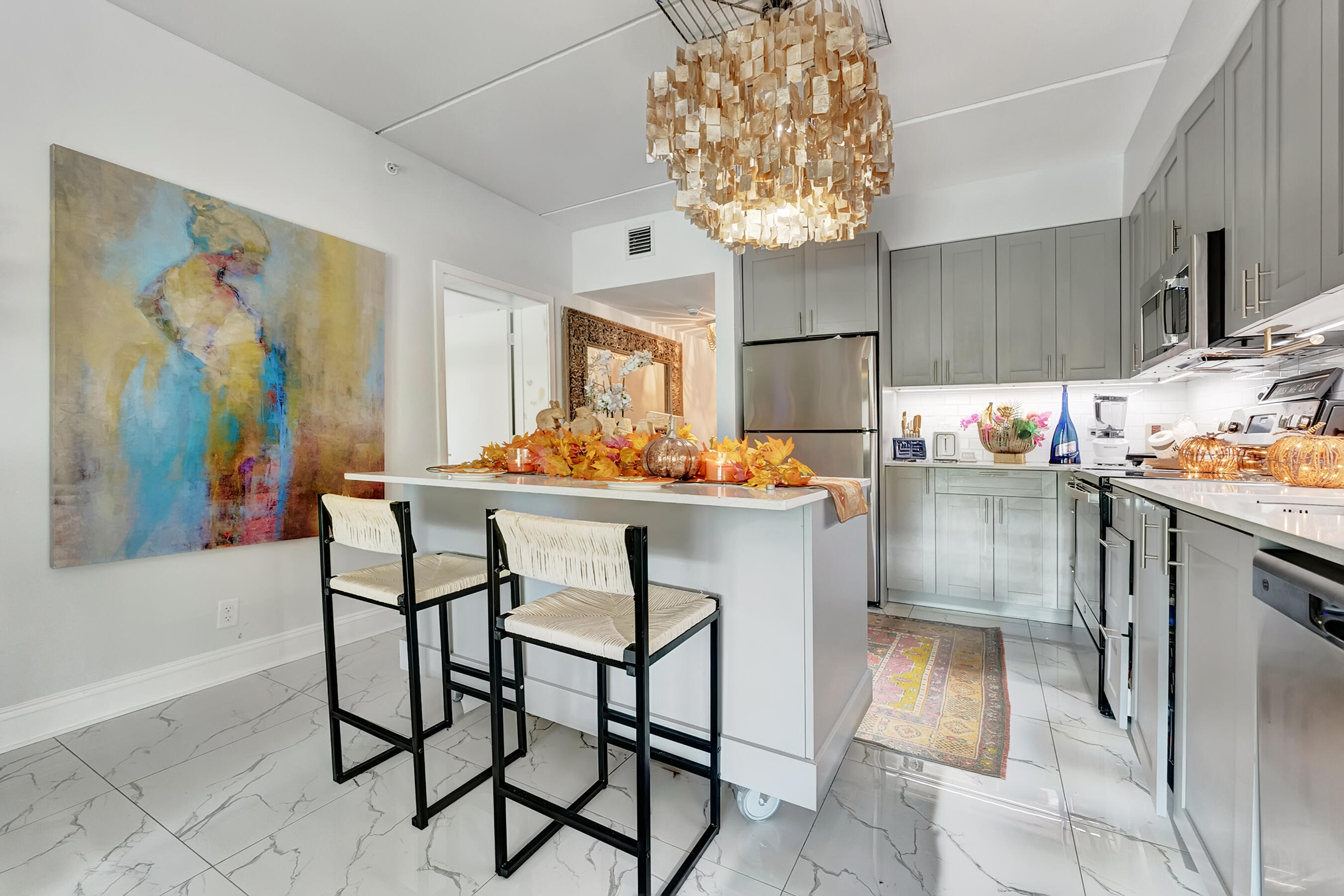 a kitchen with stainless steel appliances granite countertop a sink and a refrigerator