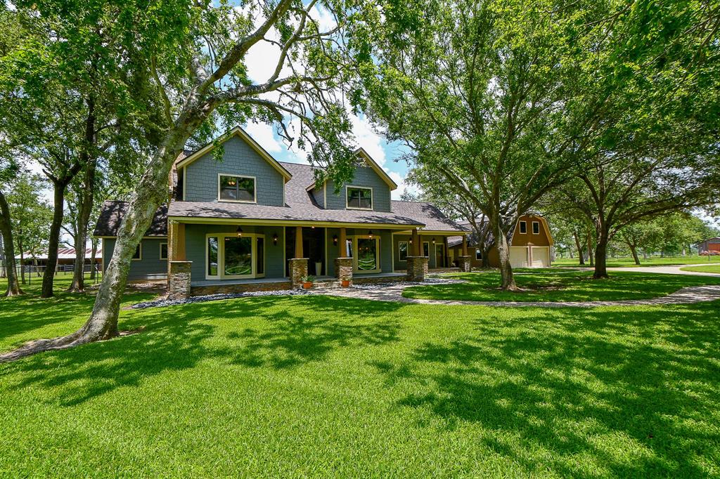 a front view of house with yard and green space