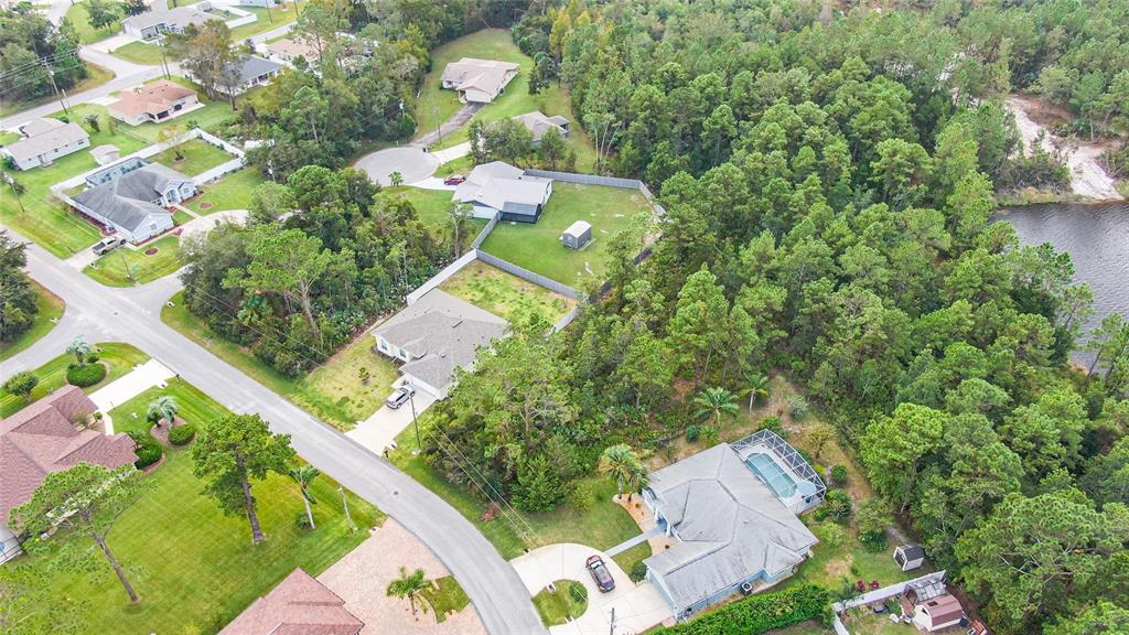 an aerial view of a house with a yard and garden