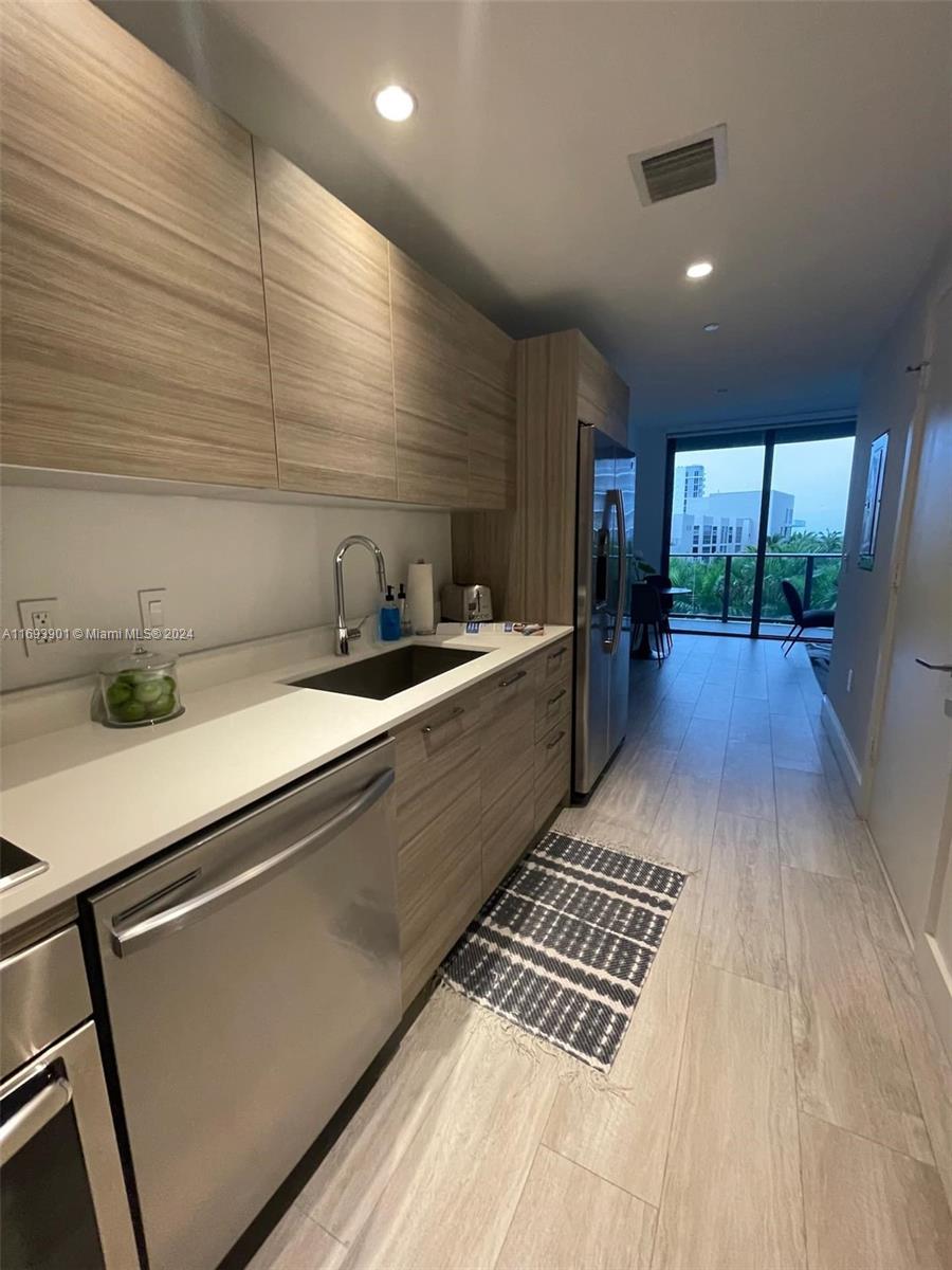 a kitchen with sink and refrigerator