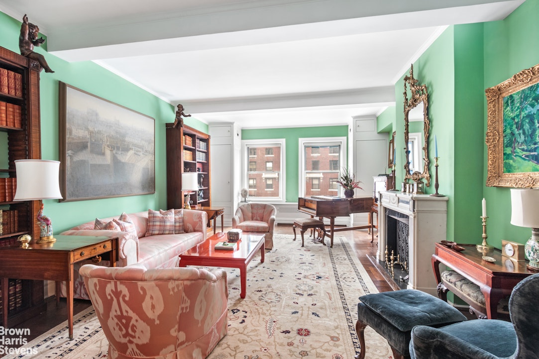 a living room with furniture fireplace and a large window