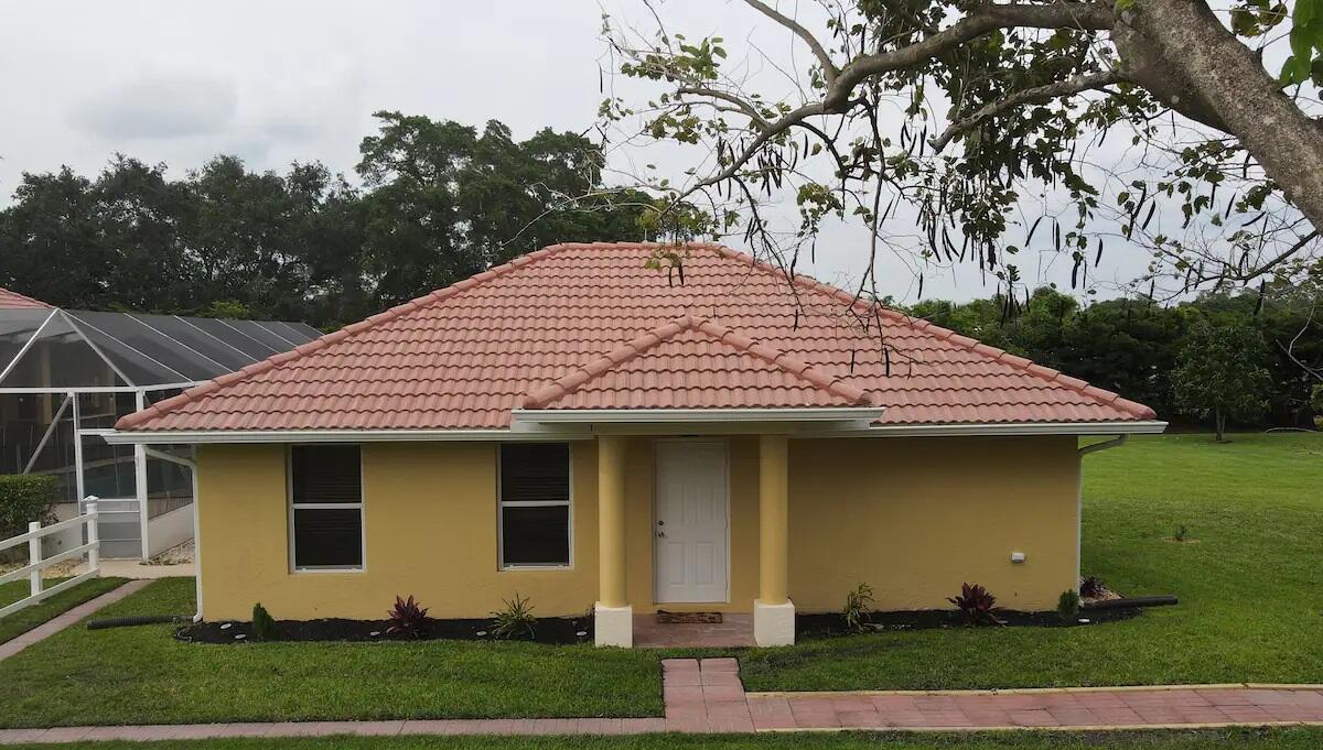 a front view of a house with garden