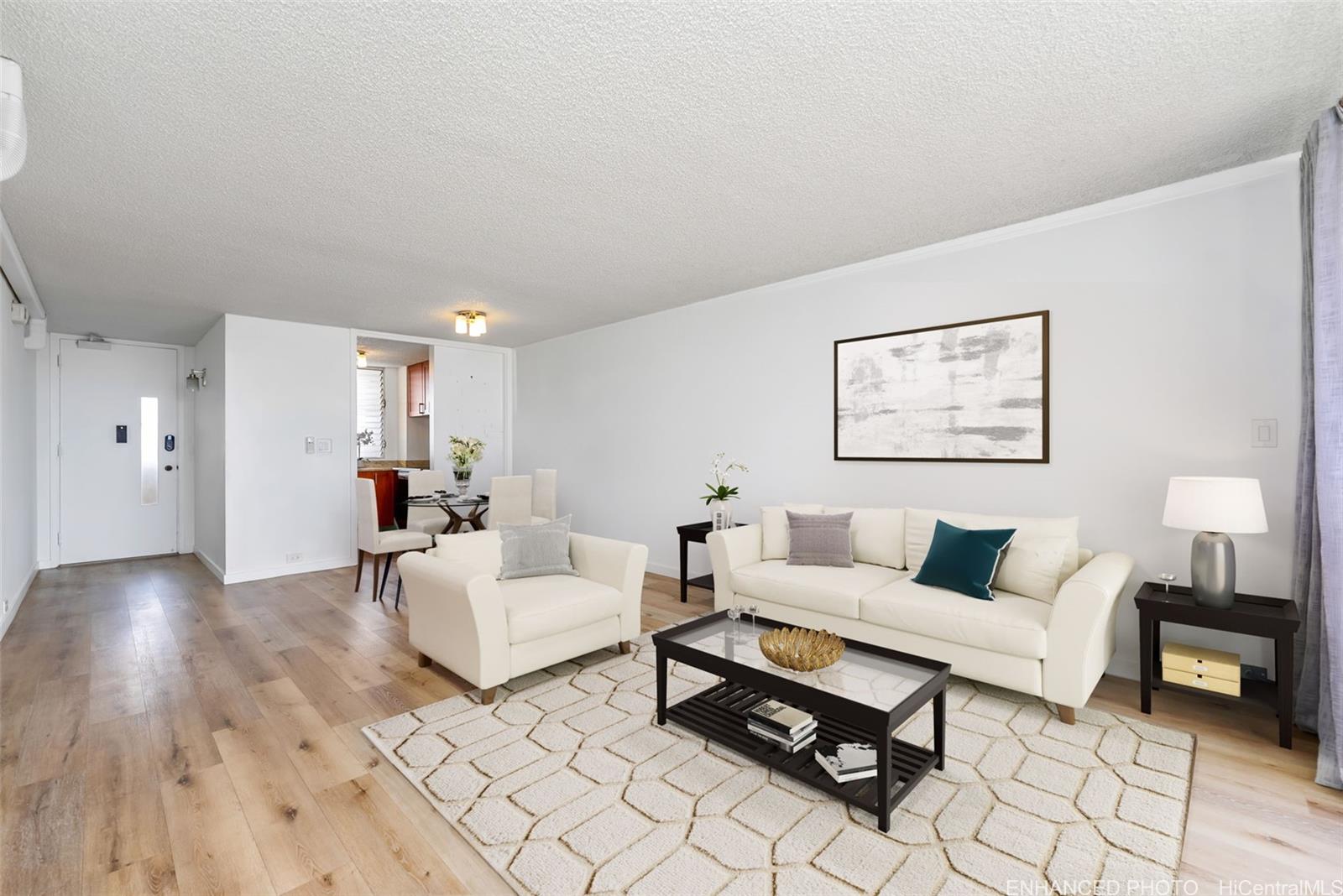 a living room with furniture and a wooden floor