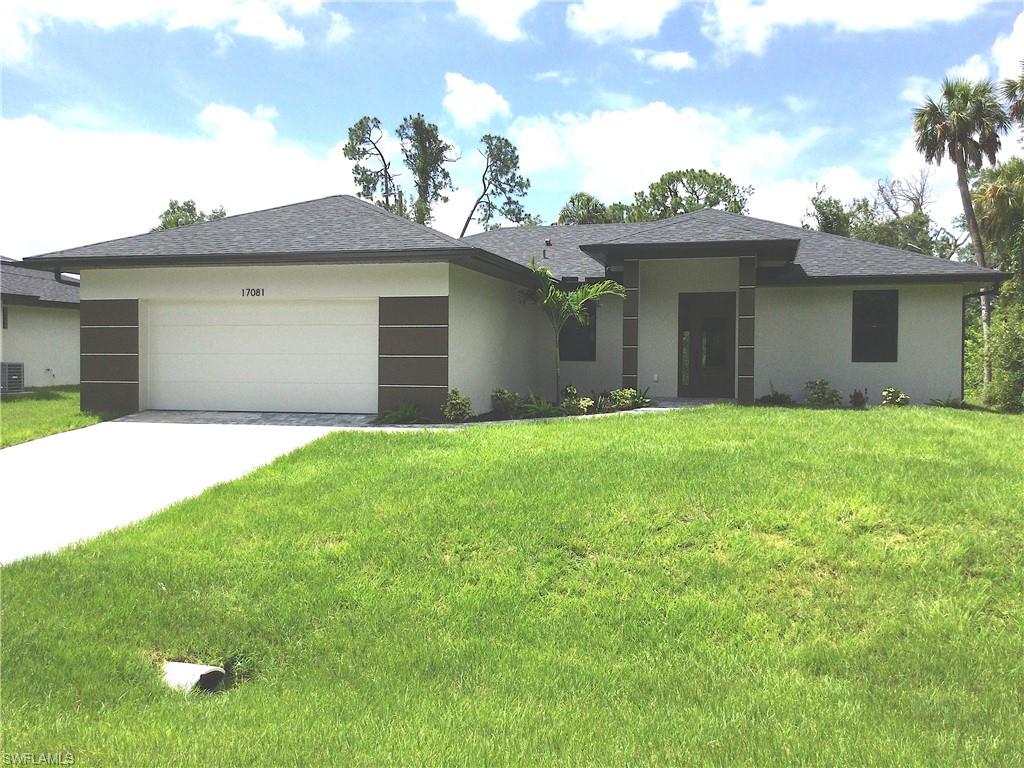 a front view of a house with a garden and yard