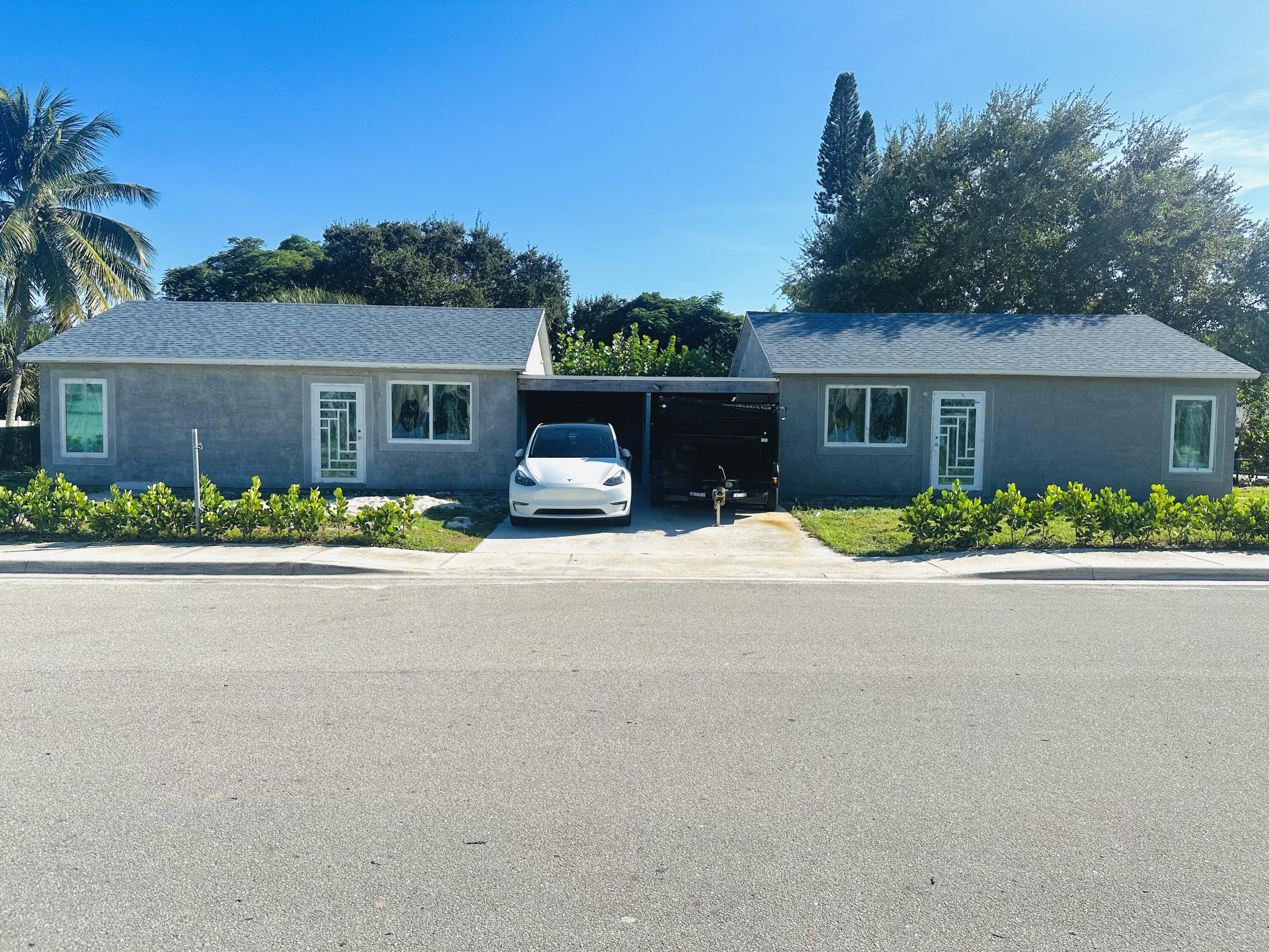 front view of house with a bench in front of it